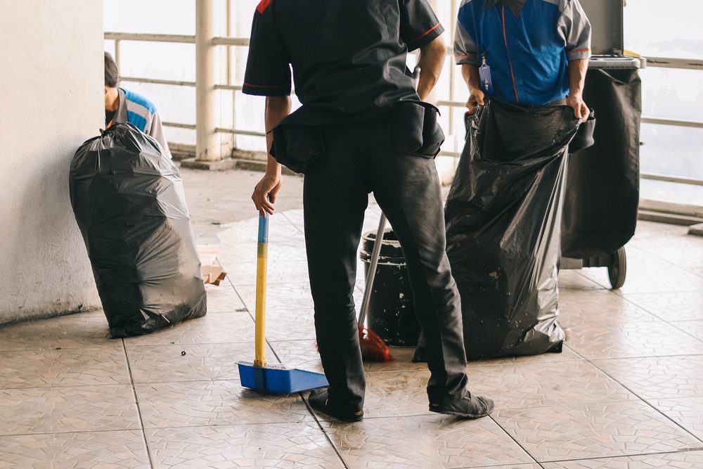 Revive Cleaning Crew clearing debris and cleaning floors on a post-construction job in San Antonio